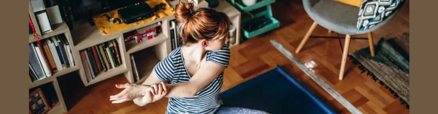 A woman stretching at home